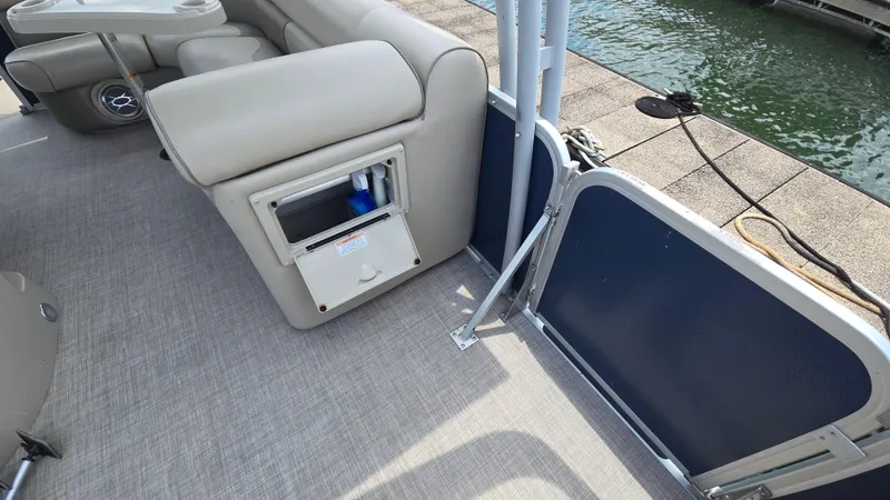 Slide: The Image of 2017 Premier 240 SunSation pontoon boat interior with seating and storage compartment. - 27