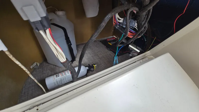 Slide: The Image of 2017 Premier 240 SunSation interior wiring and equipment compartment with fire extinguisher. - 29