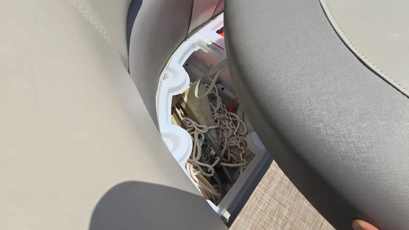Slide: The Image of Storage compartment in 2017 Premier 240 SunSation boat, showing ropes and equipment. - 31