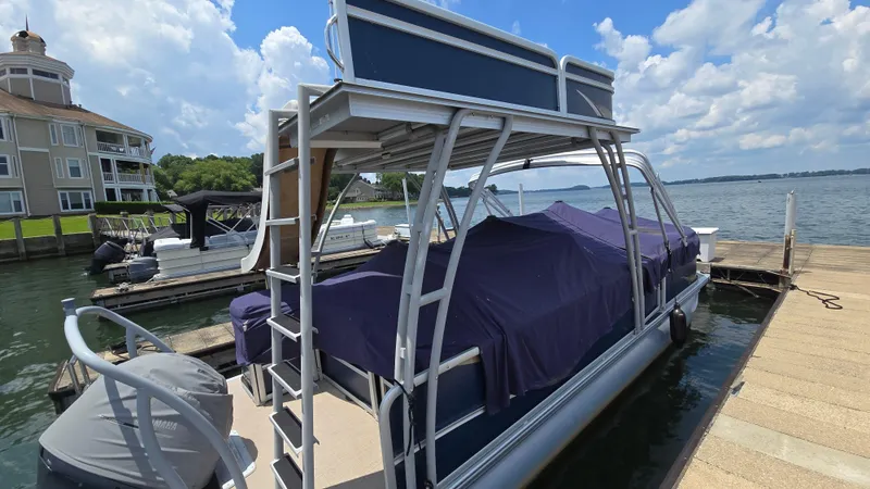 Slide: The Image of 2017 Premier 240 SunSation pontoon boat docked by a lakeside, under a blue sky. - 5