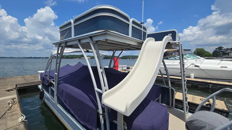 Slide: The Image of 2017 Premier 240 SunSation pontoon boat with slide, docked on a sunny day. - 7