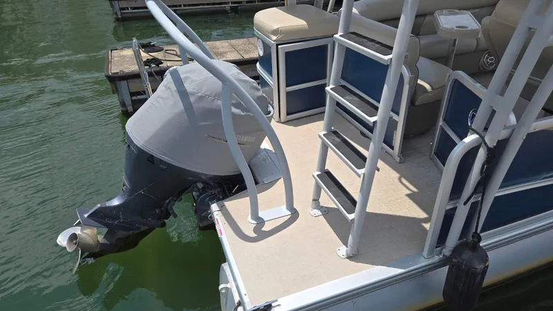 Slide: The Image of 2017 Premier 240 SunSation pontoon boat with covered outboard motor and swim ladder. - 8