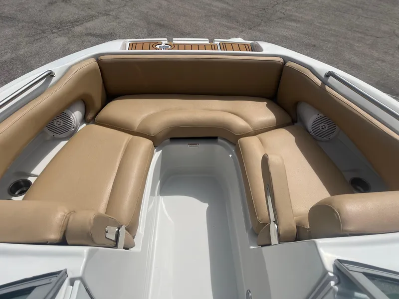 Slide: The Image of 2022 Crownline Eclipse E235 XS boat interior with tan seating and cup holders. - 10