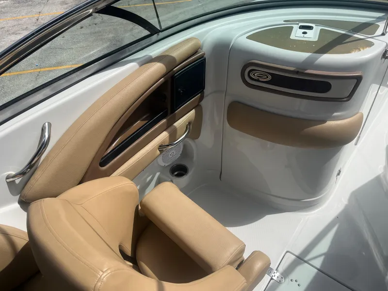 Slide: The Image of 2022 Crownline Eclipse E235 XS boat interior with tan seating and sleek design. - 11