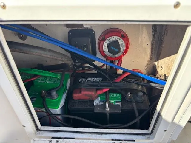 Slide: The Image of Battery compartment of a 1997 Wellcraft 210 Coastal boat, showing wiring and connections. - 14