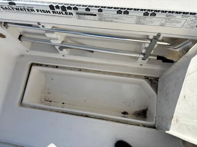 Slide: The Image of 1997 Wellcraft 210 Coastal boat interior with saltwater fish ruler and storage compartment. - 16
