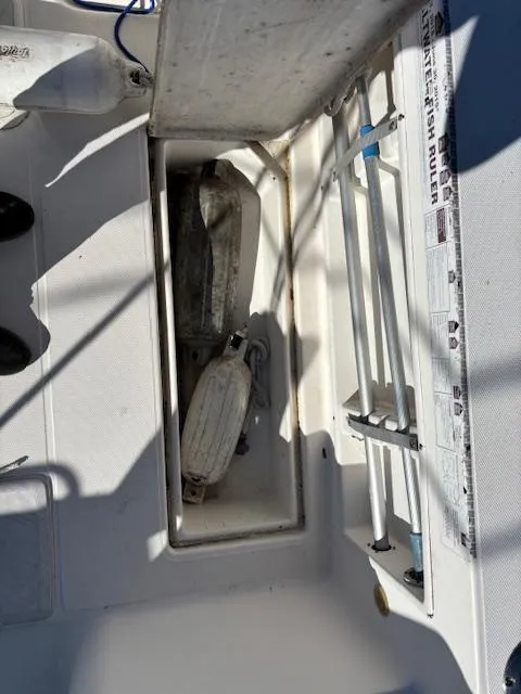 Slide: The Image of 1997 Wellcraft 210 Coastal boat storage compartment with fenders and equipment. - 17