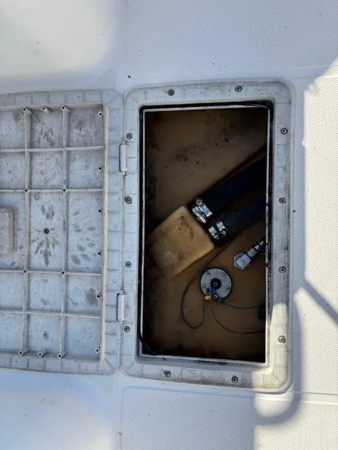 Slide: The Image of Open hatch on 1997 Wellcraft 210 Coastal boat, showing interior components. - 18