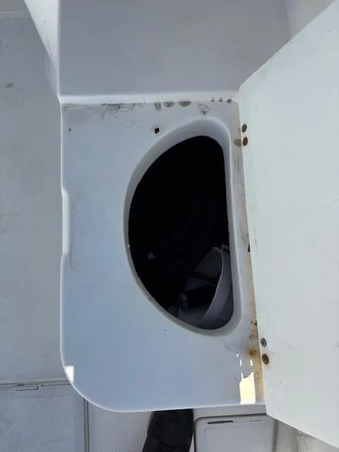 Slide: The Image of Open storage compartment on a 1997 Wellcraft 210 Coastal boat. - 20