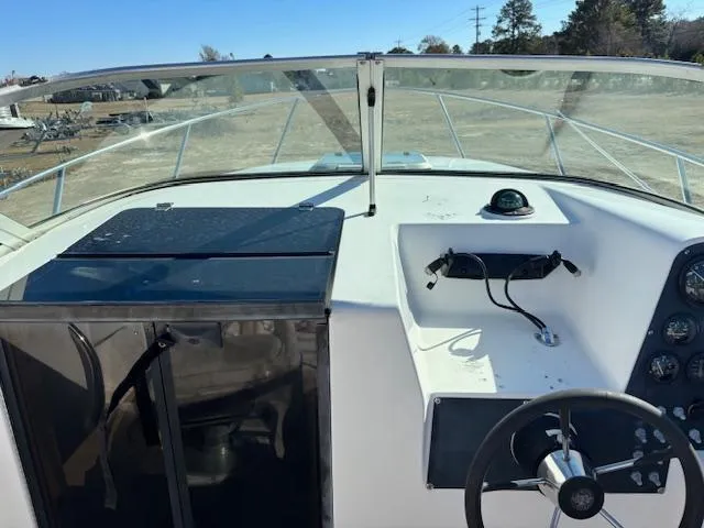 Slide: The Image of 1997 Wellcraft 210 Coastal boat cockpit with steering wheel and dashboard controls. - 24