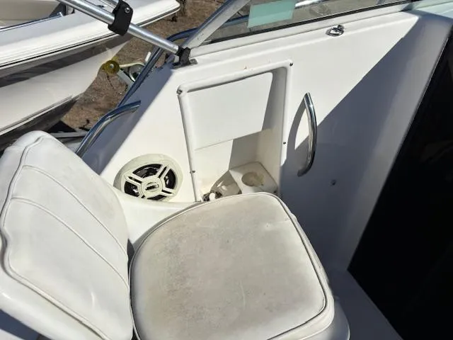 Slide: The Image of 1997 Wellcraft 210 Coastal boat interior with white seating and speaker. - 25