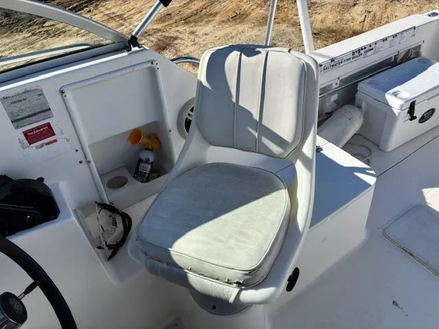 Slide: The Image of 1997 Wellcraft 210 Coastal boat interior with white captain's chair and dashboard. - 27