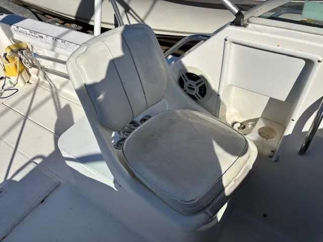 Slide: The Image of 1997 Wellcraft 210 Coastal boat interior with white seating and console. - 28