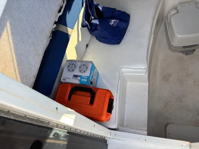 Slide: The Image of Interior of a 1997 Wellcraft 210 Coastal boat with gear and storage. - 31