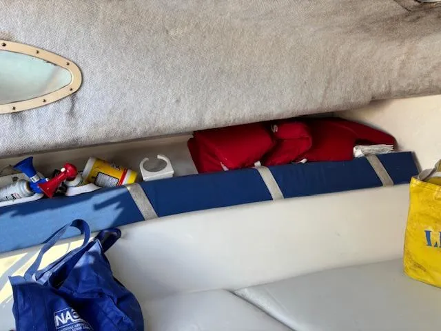 Slide: The Image of Interior of a 1997 Wellcraft 210 Coastal boat with storage items and life jackets. - 36