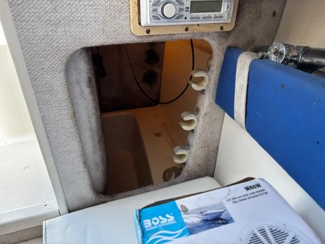 Slide: The Image of Interior view of a 1997 Wellcraft 210 Coastal boat, featuring a stereo system and storage compartment. - 38