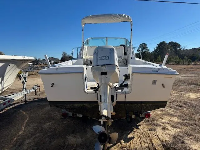 Slide: The Image of 1997 Wellcraft 210 Coastal boat with outboard motor, parked on dry land. - 4