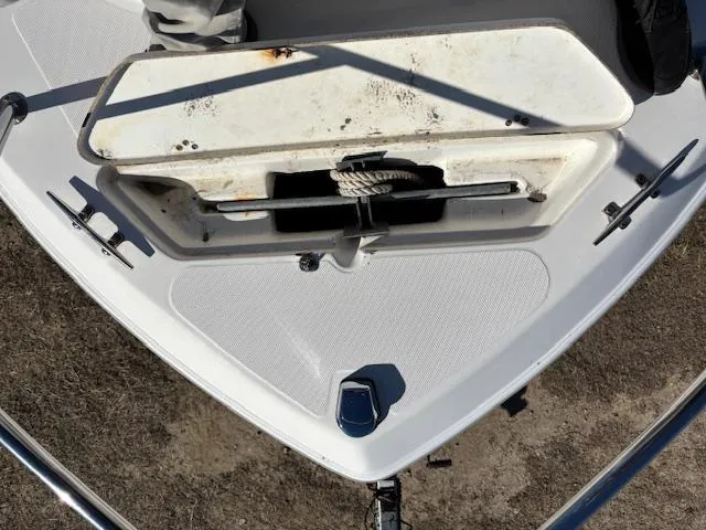 Slide: The Image of 1997 Wellcraft 210 Coastal boat anchor compartment, open and showing anchor storage. - 42
