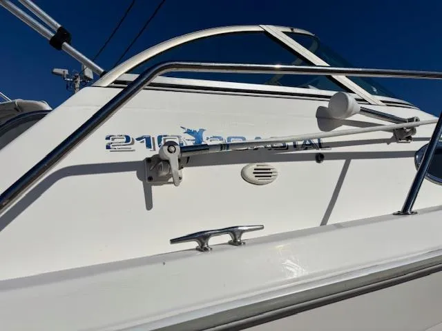Slide: The Image of 1997 Wellcraft 210 Coastal boat, white exterior, close-up view of side and railing. - 46