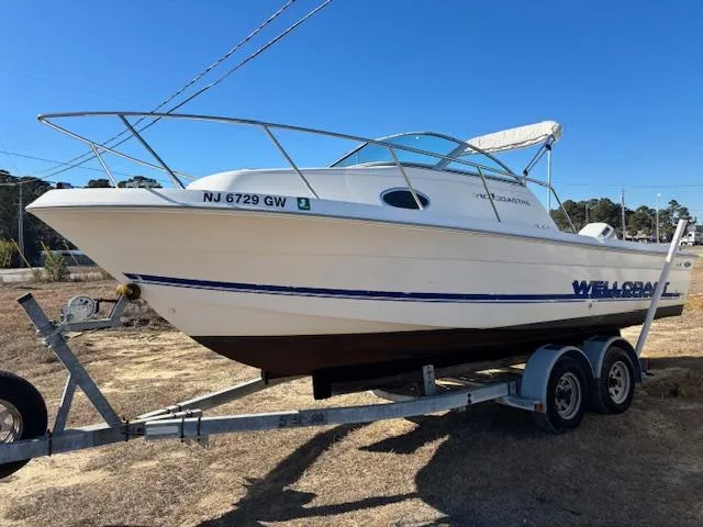 Slide: The Image of 1997 Wellcraft 210 Coastal boat on trailer, side view, outdoors. - 6
