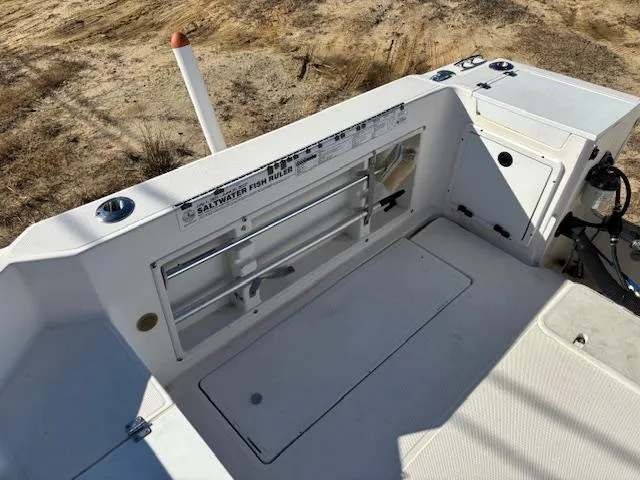 Slide: The Image of 1997 Wellcraft 210 Coastal boat interior, featuring fishing rod holders and storage compartments. - 9