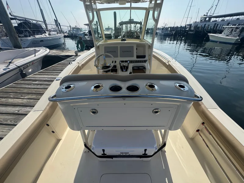 Slide: The Image of 2023 Scout 255 LXF boat interior with helm, docked at marina. - 13