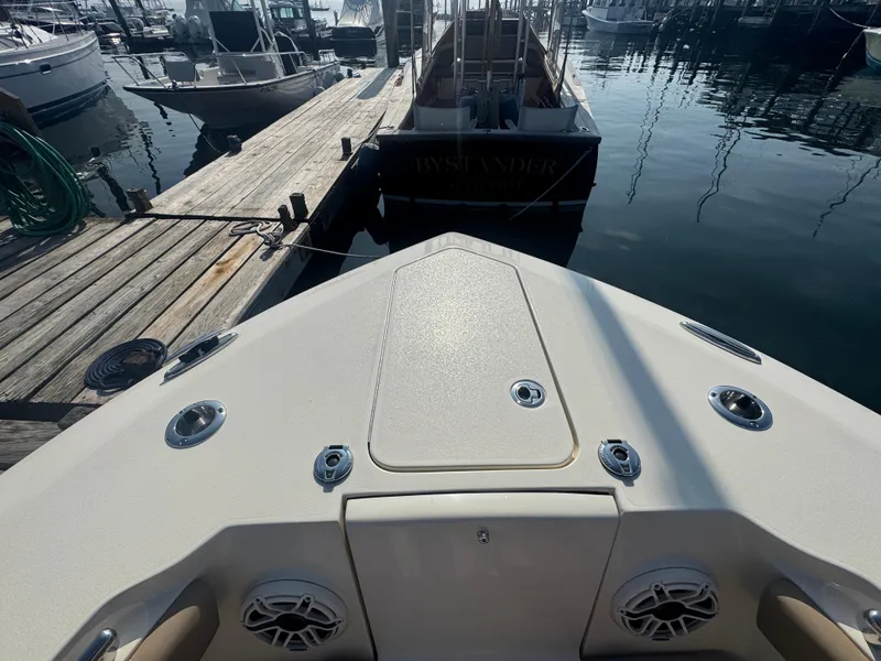 Slide: The Image of Bow view of 2023 Scout 255 LXF boat docked at marina. - 18