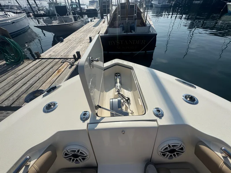 Slide: The Image of 2023 Scout 255 LXF boat bow with open anchor locker at marina. - 19