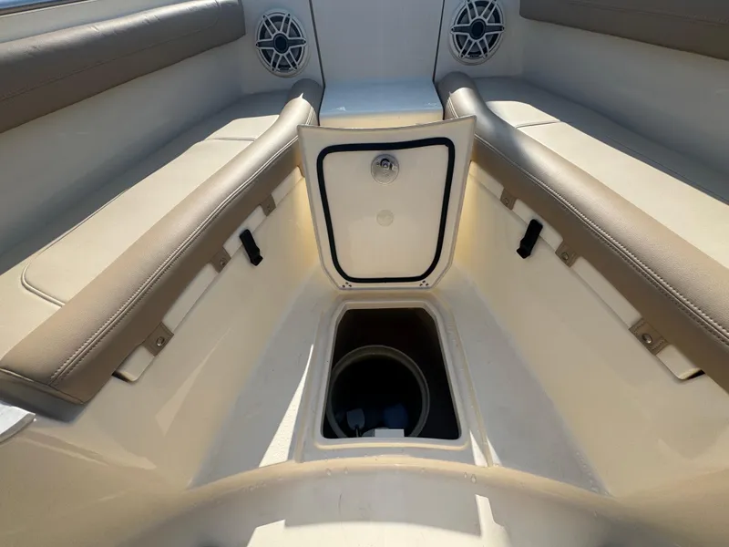 Slide: The Image of 2023 Scout 255 LXF boat interior with storage compartment and speakers. - 22