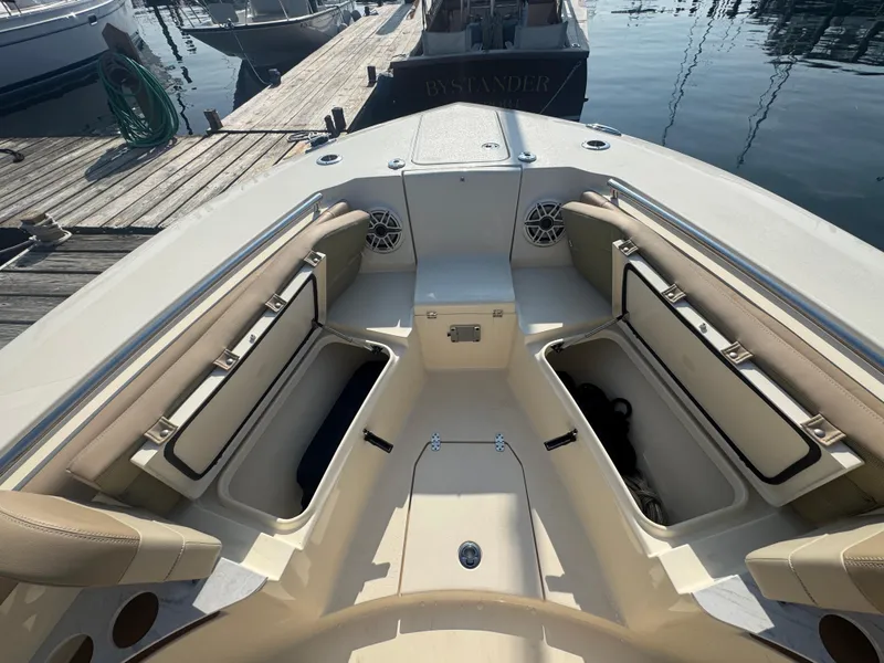 Slide: The Image of 2023 Scout 255 LXF boat interior with open storage compartments at dock. - 23