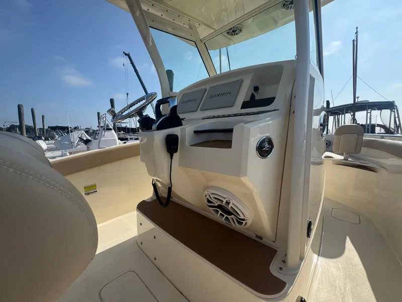 Slide: The Image of 2023 Scout 255 LXF boat interior with Garmin navigation system and speaker. - 29