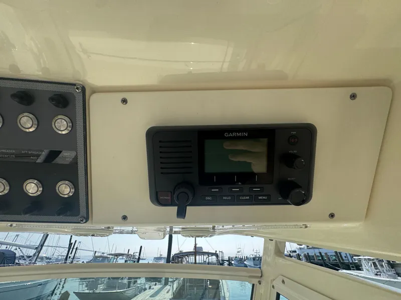 Slide: The Image of 2023 Scout 255 LXF boat dashboard with Garmin marine radio and control panel. - 31
