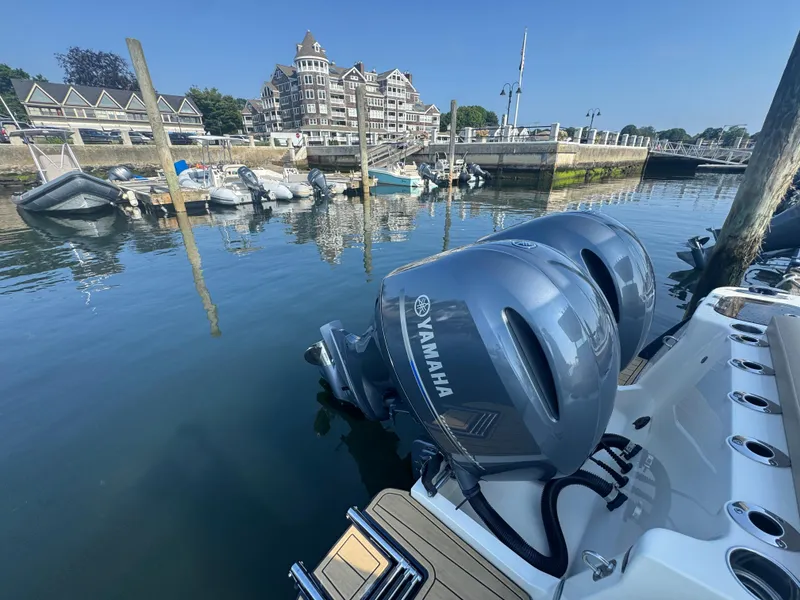 Slide: The Image of 2023 Scout 255 LXF boat with Yamaha engines docked in a marina. - 35