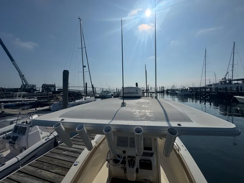 Slide: The Image of 2023 Scout 255 LXF boat docked at marina under sunny sky. - 37