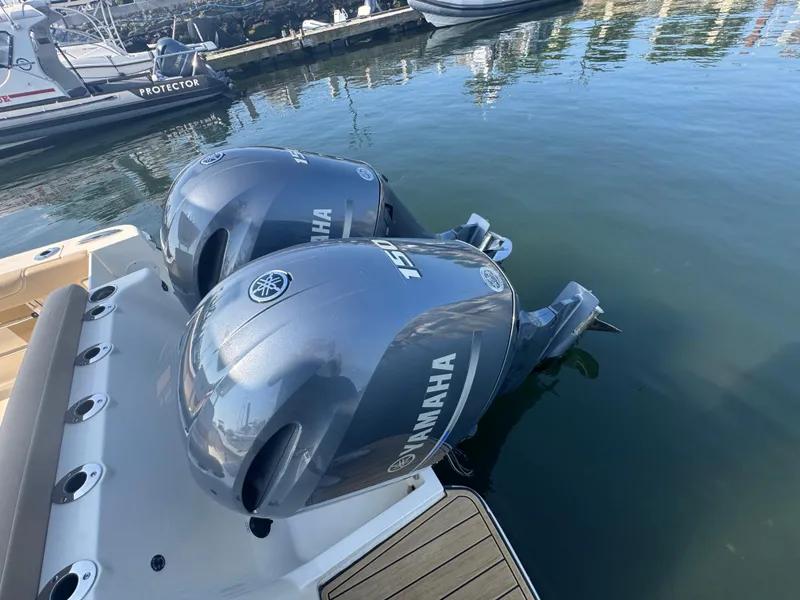 Slide: The Image of 2023 Scout 255 LXF boat with dual Yamaha outboard engines docked in marina. - 38
