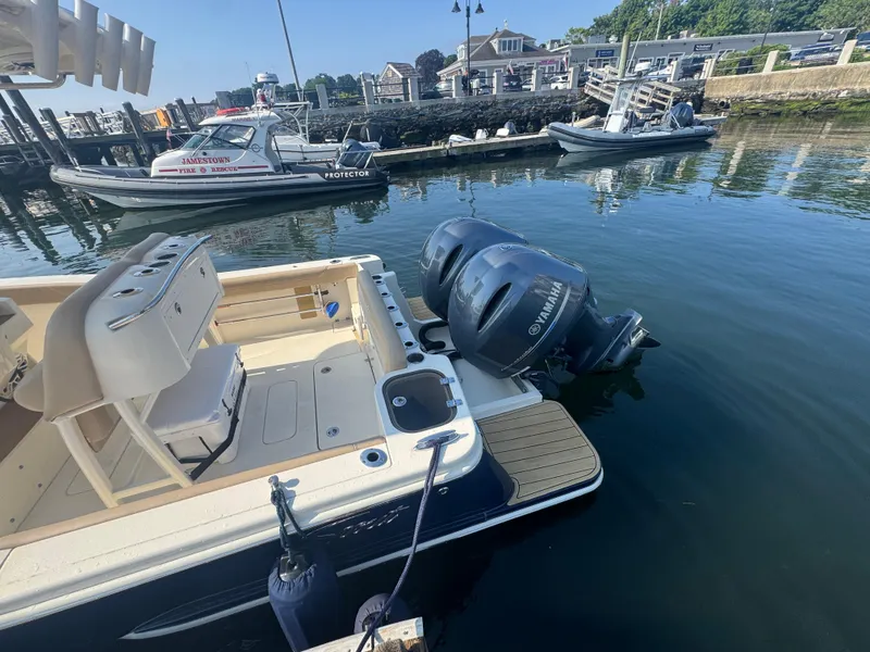 Slide: The Image of 2023 Scout 255 LXF boat with Yamaha engines docked at a marina. - 39