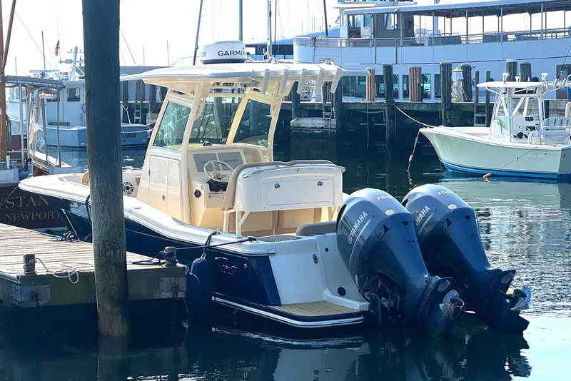 Slide: The Image of 2023 Scout 255 LXF boat docked with twin Yamaha engines. - 4