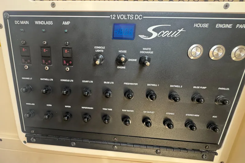 Slide: The Image of Control panel of 2023 Scout 255 LXF boat with various switches and indicators. - 44