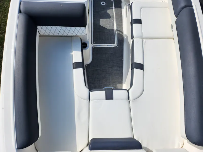 Slide: The Image of Interior seating of 2021 Bayliner DX 2000 boat, featuring white and gray upholstery. - 20
