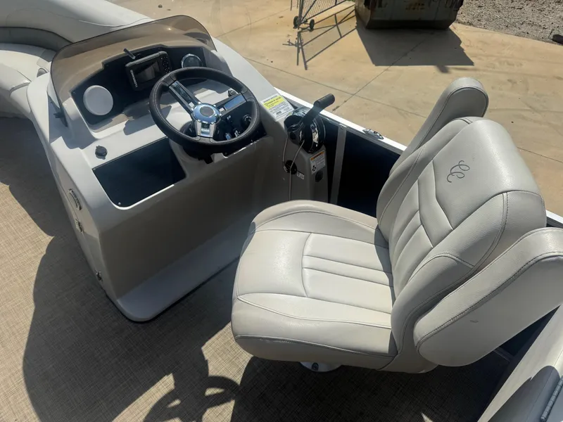 Slide: The Image of 2022 Cypress Cay Seabreeze 232 boat interior with steering console and captain's chair. - 5