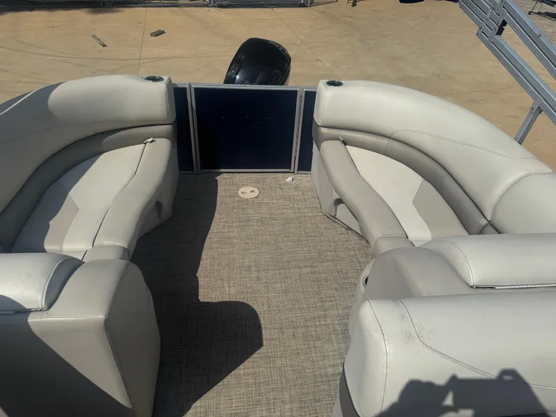 Slide: The Image of 2022 Cypress Cay Seabreeze 232 pontoon boat interior with beige seating and carpeted floor. - 6