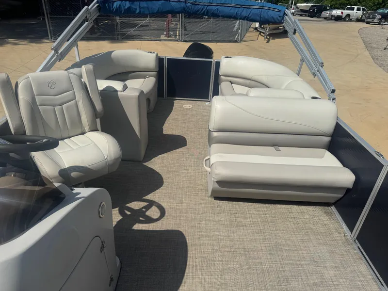 Slide: The Image of 2022 Cypress Cay Seabreeze 232 pontoon boat interior with plush seating and steering console. - 7
