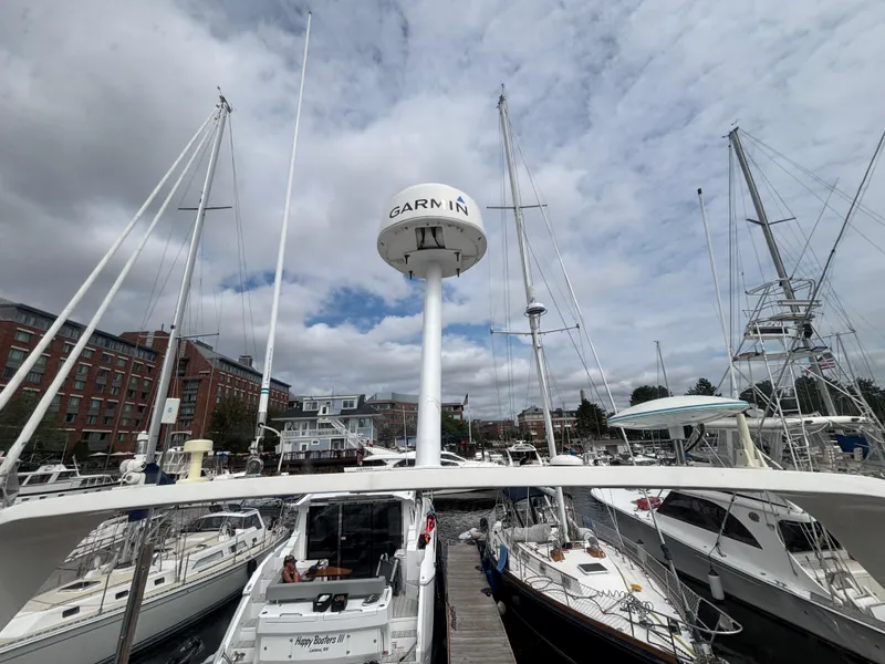 Slide: The Image of 2007 Carver 35 Super Sport yacht docked at a marina under cloudy skies. - 11