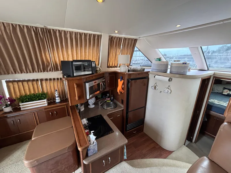 Slide: The Image of Interior of 2007 Carver 35 Super Sport yacht with kitchen and seating area. - 16