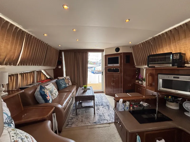 Slide: The Image of Interior of a 2007 Carver 35 Super Sport yacht with cozy seating and modern amenities. - 18