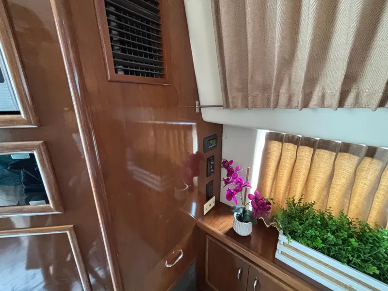 Slide: The Image of Interior of 2007 Carver 35 Super Sport with wood paneling, plants, and curtains. - 19