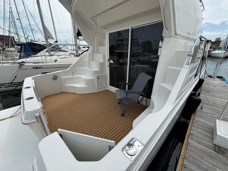 Slide: The Image of 2007 Carver 35 Super Sport yacht with spacious deck and seating at marina. - 2