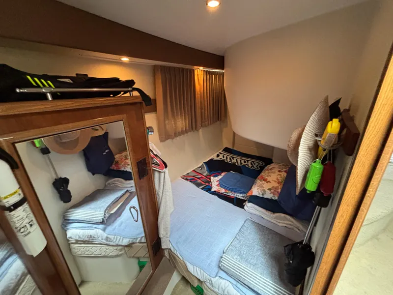 Slide: The Image of Cozy cabin interior of 2007 Carver 35 Super Sport with bed and storage. - 21