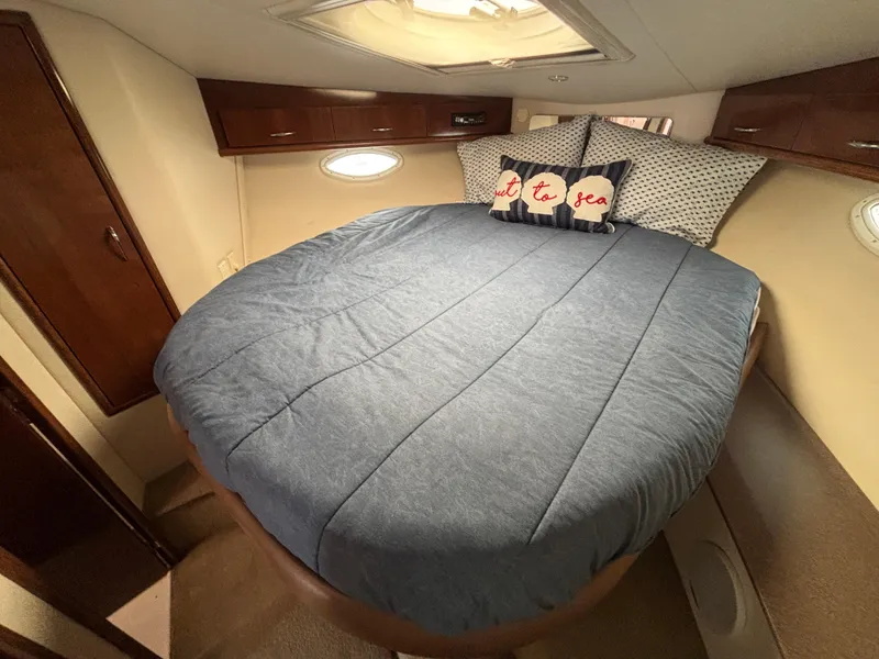 Slide: The Image of Cozy bedroom in 2007 Carver 35 Super Sport yacht with blue bedding and nautical decor. - 23