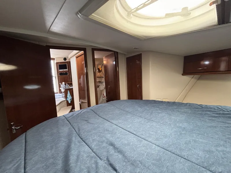 Slide: The Image of Interior of 2007 Carver 35 Super Sport yacht with cozy bedroom and wooden cabinetry. - 24